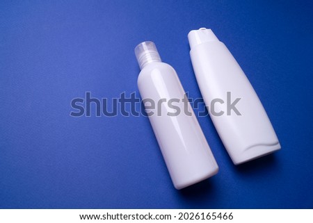 shampoo or hair conditioner bottle isolated on blue background