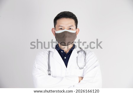 Asian doctor is wearing double layer masks for protecting Covid-19 virus - medical people working concept
