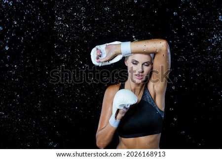Boxing Concepts. Professional Active Female Boxer  Posing in White Gloves Against Multiple Water Droplets. Horizontal Composition