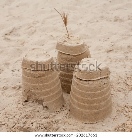 Castle on sand. Three sandy towers on beach