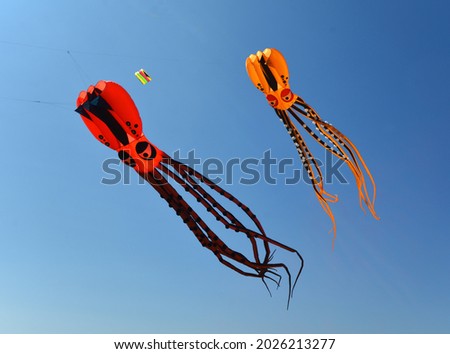 Two Octopus Kites against blue sky.