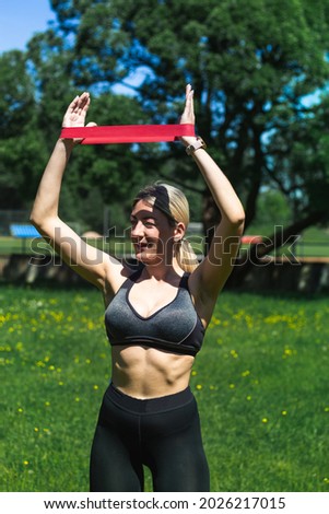 Young caucasian blond-haired woman in sportswear is doing yoga in the park. Outdoor workout. Yoga poses	