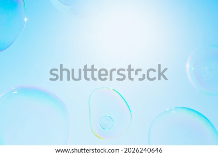 BLOWING AIR BUBBLES FLYING AGAINST THE SUN IN THE CLEAR BLUE SKY, CLEAN BACKGROUND, NATURAL FRESH BACKDROP