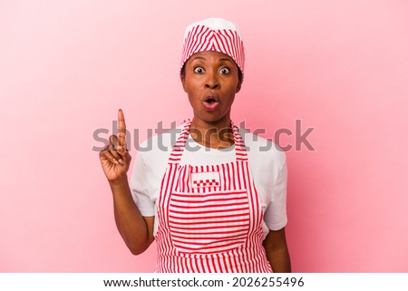 Young african american ice cream maker woman isolated on pink background having some great idea, concept of creativity.