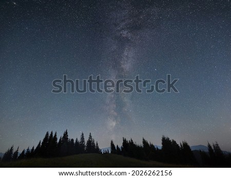 Night sky full of stars, Milky way in the mountains in summer. Galaxy above the hillside, beautiful night scene. Space background. Copy space. Astrophotography