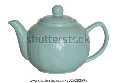 Cute turquoise teapot close-up isolated on a white background. Household utensils, kitchen utensils. Tea party, tea ceremony. Royalty-Free Stock Photo #2026282595