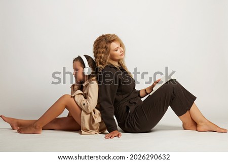 Photo of mom with daughter in photo studios on a white background
