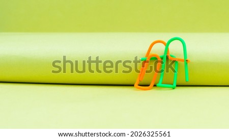 Happy couple sitting in a sweet pose. Abstract Human Figure of Paper Clip. Creative Photography. Still Life. Copy Space