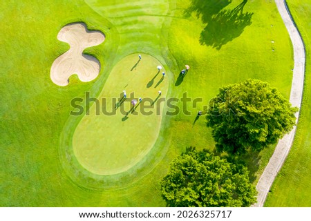Golf course sport, green grass and trees on a golf field, fairway and putting green top view, Bangkok Thailand. bird view over Golf course in the tropical asia. Royalty-Free Stock Photo #2026325717