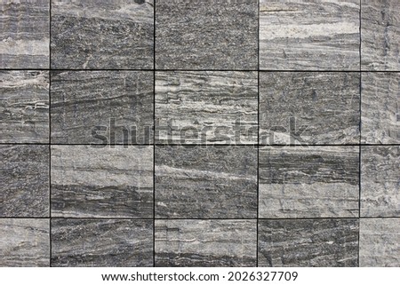 Image of the wall surface of granite constructed in a tile shape.