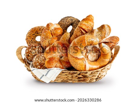 Various kinds of breadstuff in the rustic basket isolated on white background. Bread rolls, baguette, sweet bun, croissant and bagel. Royalty-Free Stock Photo #2026330286