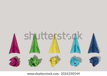 Flat lay of color paper plane on grey color background