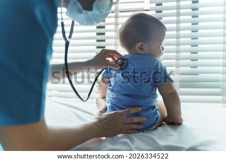 Asian female Pediatrician doctor examining her little baby patient with stethoscope in medical room at hospital. BeH3althy Royalty-Free Stock Photo #2026334522