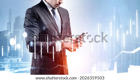 Businessman wearing formal suit is standing and texting message via smartphone. Financial city center with skyscrapers in the background. Concept of cooperation, communication, teamwork and network