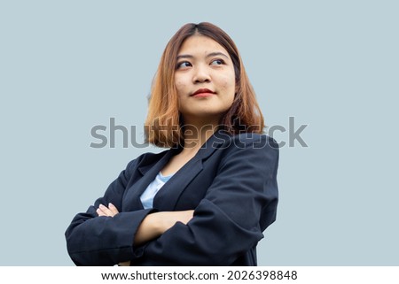 Close up Asian businesswoman standing and Cross One's Arm isolated on grey background 