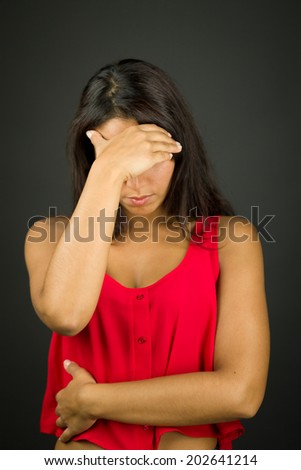 Upset young woman with her head in hands