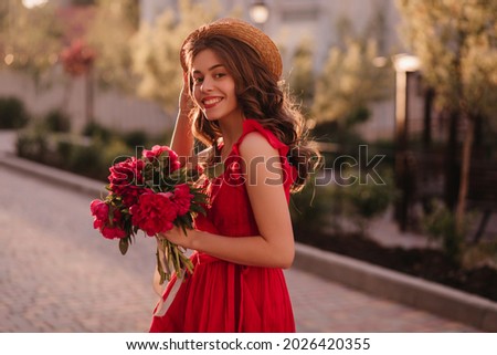 Extremely lovely German girl is walking on the street in a romantic mood before the sunset. She is on her way to poetry evening where young one gonna read her poems very first time. 