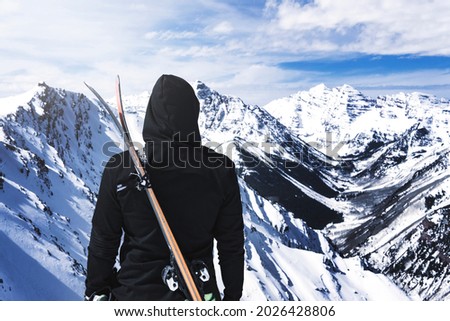 Hooded Person With Skis On Back At Top Of Winter Mountain Extreme Ski Sport Concept Royalty-Free Stock Photo #2026428806