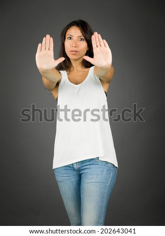 Young woman standing with making stop gesture sign from both hands