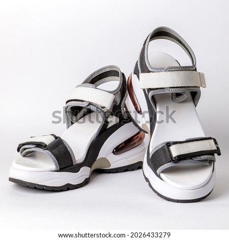 Women's, fashionable, sports sandals on a white background. New youth shoes for girls. Foreground.