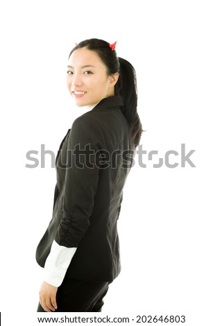 Devil side of a young Asian businesswoman standing and smiling isolated on white background