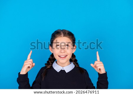 Photo of cheerful dreamy girl point finger up copyspace advertising black friday isolated on blue color background