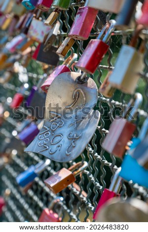 Love locks on a bridge railing. A big heart in the middle