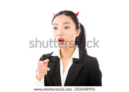 Devil side of a young Asian businesswoman pointing forward and looking shocked isolated on white background