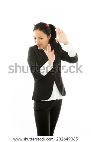 Devil side of a young Asian businesswoman say stop with palm isolated on white background