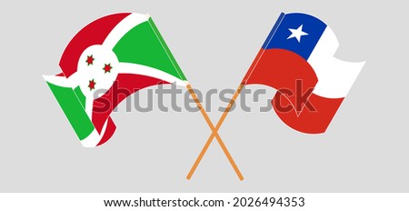 Crossed and waving flags of Burundi and Chile