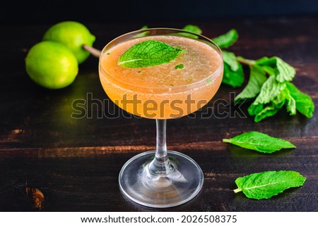 Old Cuban Cocktail Made with Rum, Mint, and Sparkling Wine: A cocktail made with dark rum and served in a coupe glass Royalty-Free Stock Photo #2026508375