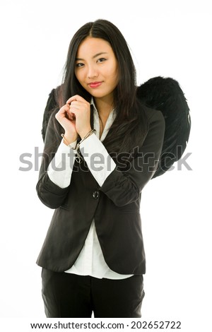 Asian young businesswoman dressed up as black angel handcuffs isolated on white background