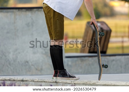 skateboarder leans on his board at a skateboard park in Whitefish, Montana
