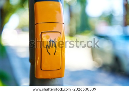 Close-up, yellow button to switch traffic lights.