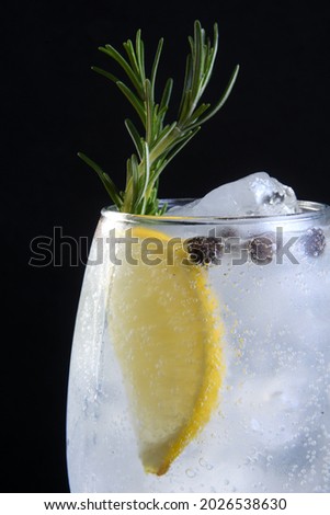 refreshing alcoholic drink, cozumel, mojito with tequila, gin, soda, lemon and mint isolated on black background