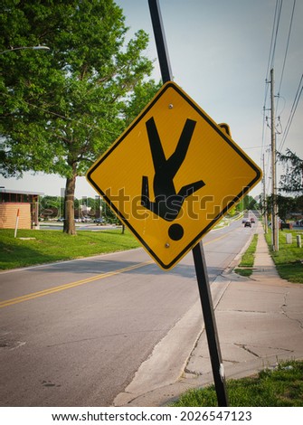 Walk sign hangs upside down on busy road