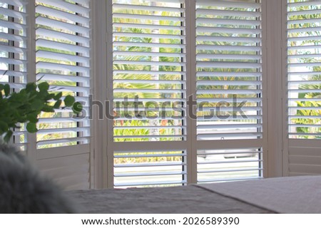 Luxury white indoor plantation shutters in bedroom - selective focus	 Royalty-Free Stock Photo #2026589390