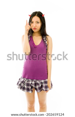 Asian young woman dressed up as a devil and scolding somebody isolated on white background