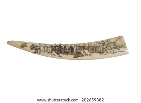 walrus tusk souvenir with a picture depicting people hunting walrus