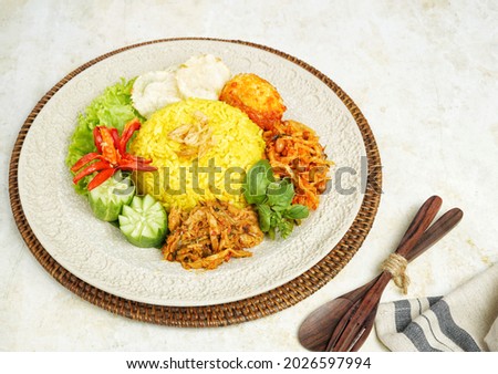 Nasi Kuning Manado, a turmeric savory rice dish served with Cakalang Suwir or Shredded Tuna, Spicy Dried Potatoes and a boiled egg. North Sulawesi, Indonesia culinary.   Royalty-Free Stock Photo #2026597994