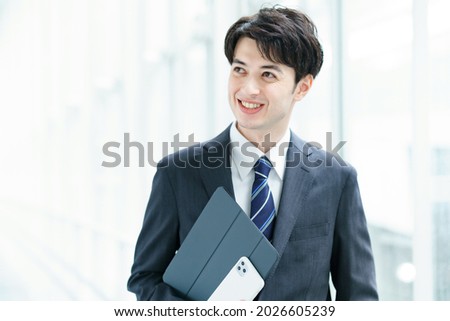 A businessman walking down the aisle with a smile