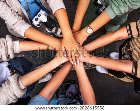 Teamwork, collaboration and unity. Top view of creative professionals folding their hands as a symbol of teamwork, collaboration and unity. Stack of hands of men and women. Big sea of ​​hands