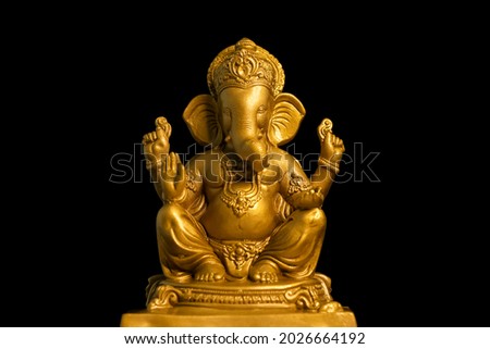 Golden lord ganesha sclupture over dark background. celebrate lord ganesha festival. Royalty-Free Stock Photo #2026664192