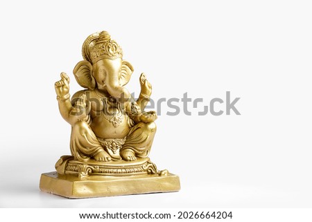 Golden lord ganesha sclupture over white background. celebrate lord ganesha festival. Royalty-Free Stock Photo #2026664204