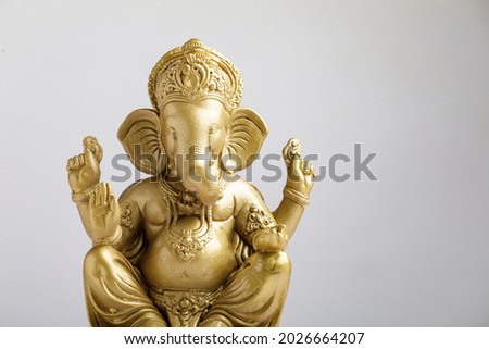 Golden lord ganesha sclupture over white background. celebrate lord ganesha festival. Royalty-Free Stock Photo #2026664207