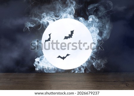Halloween background. Spooky night with full moon and wooden table. Halloween scary night.