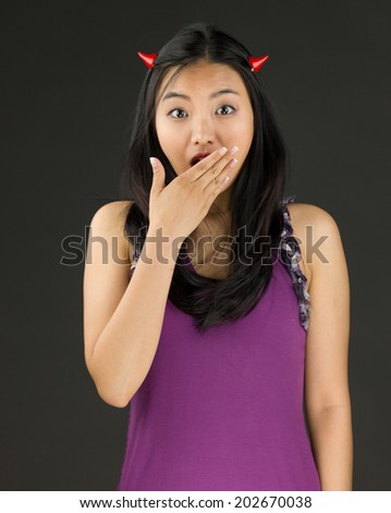 Devil side of a young Asian woman looking shocked
