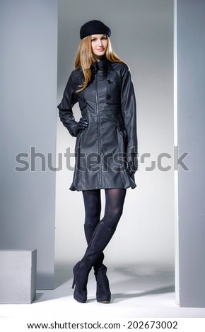 Fashion model in stylish dress, studio portrait 