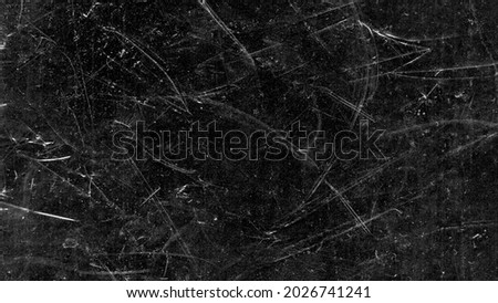 White scratches and dust on black background. Vintage scratched grunge plastic broken screen texture. Scratched glass surface wallpaper. Space for text. Royalty-Free Stock Photo #2026741241