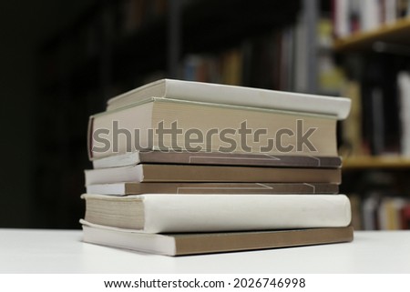 Stack of books on the table in library